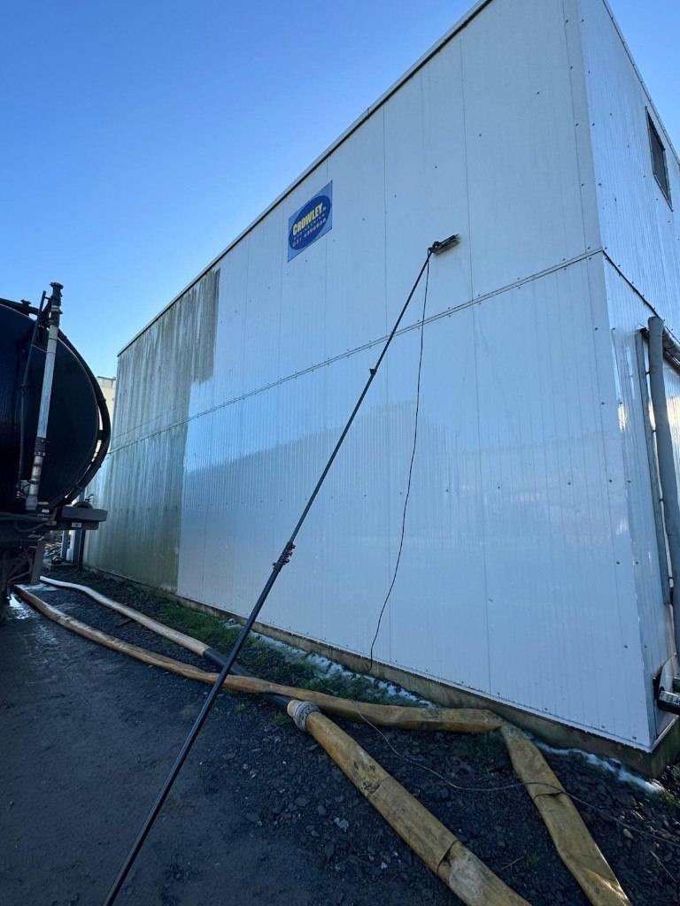 Long-reach pole cleaning stained industrial cladding