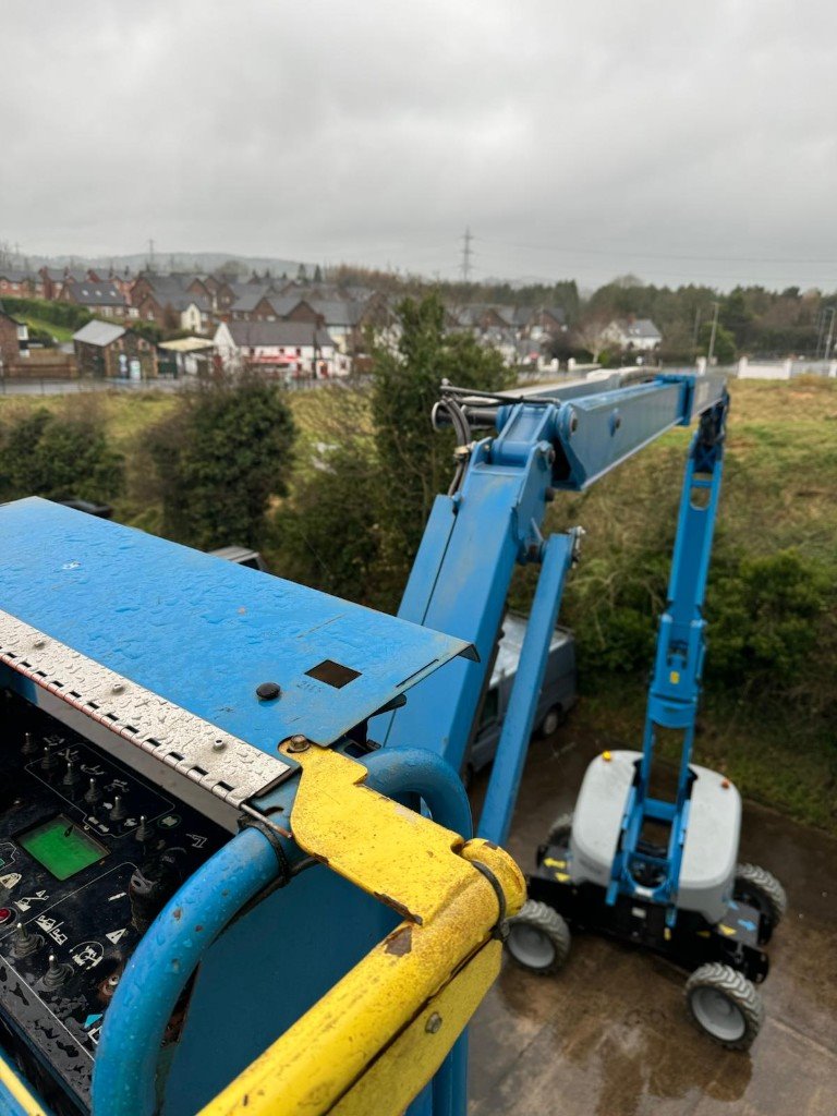 Looking down the cherry picker boom to the van on a wet yard