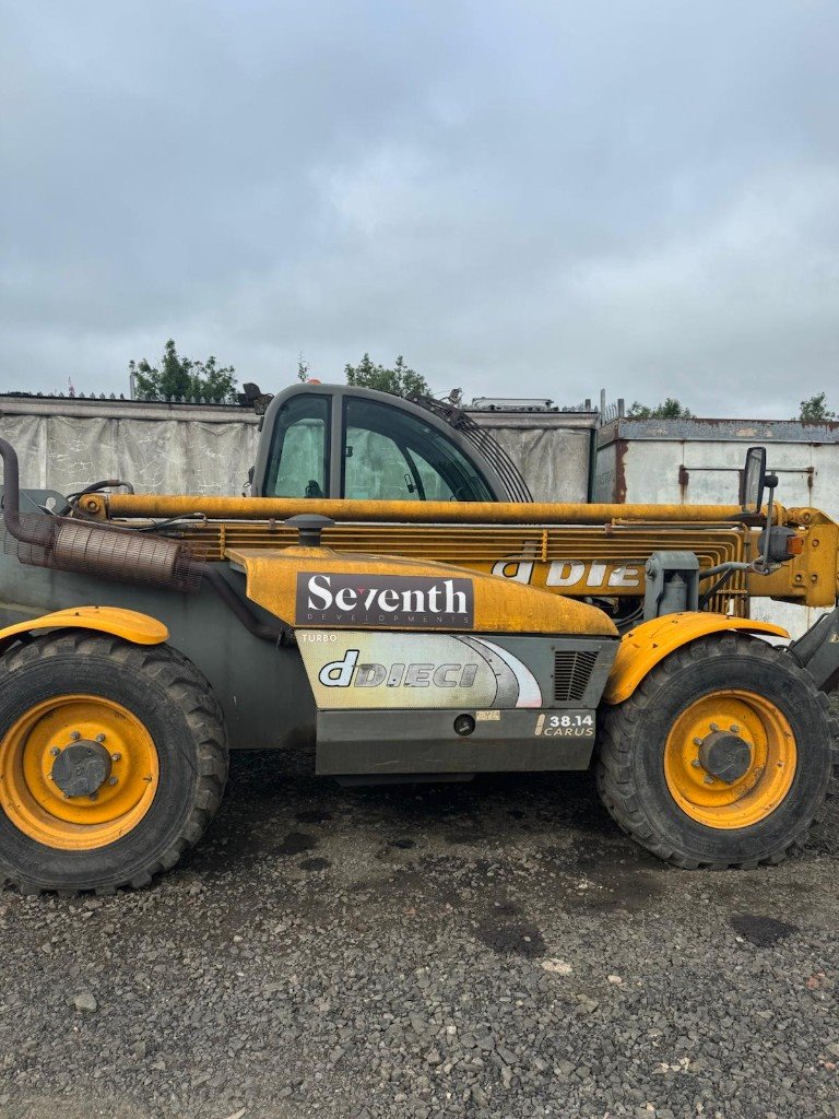Telehandler mid-clean — body washed, boom still dirty