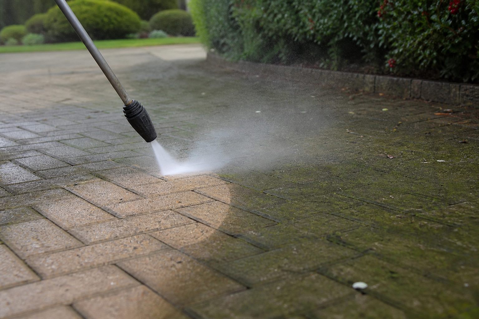 Pressure washing a driveway