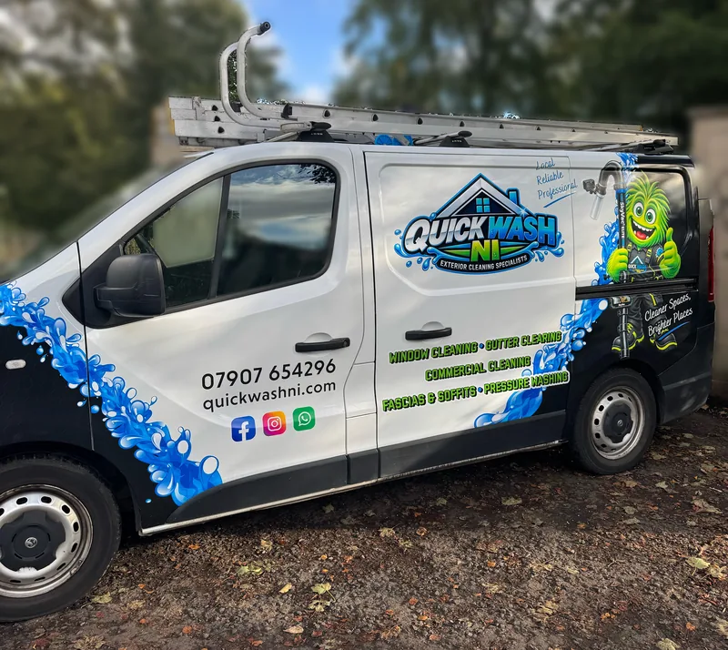 The QuickWash NI van, white with blue splashes and the green monster on the side